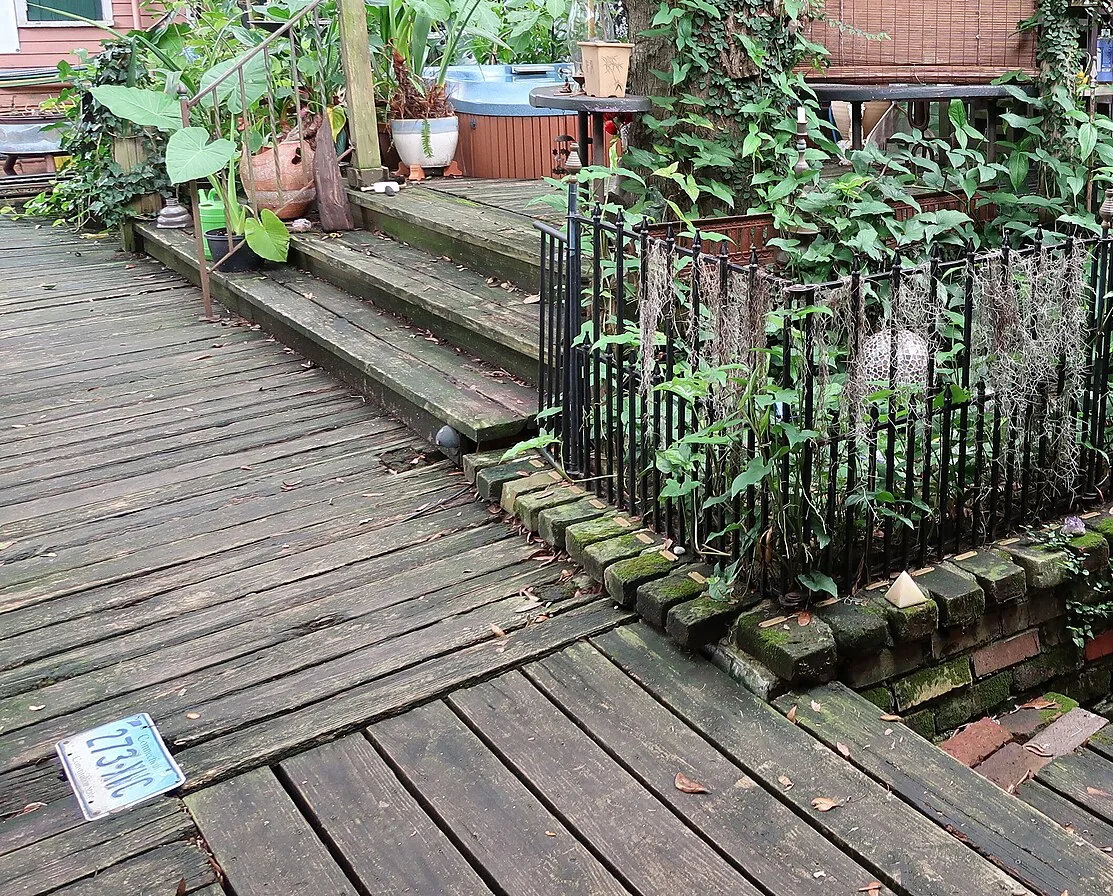Weathered wooden deck with a step up to a raised section