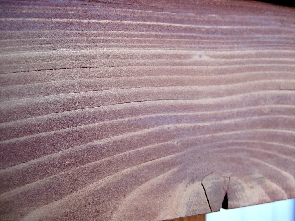 Close view of sanded timber showing bare grain